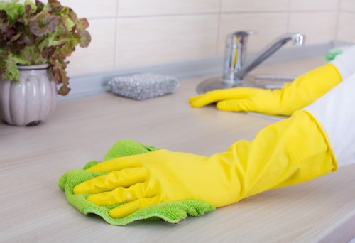 Local cleaner working in a Roehampton flat corridor