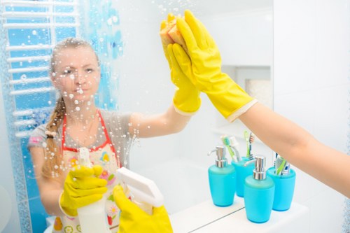 Local cleaners preparing a kitchen and bathroom in Roehampton for move in